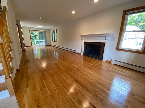 Living room/dining room combo with all new hardwood floors and electric fireplace.