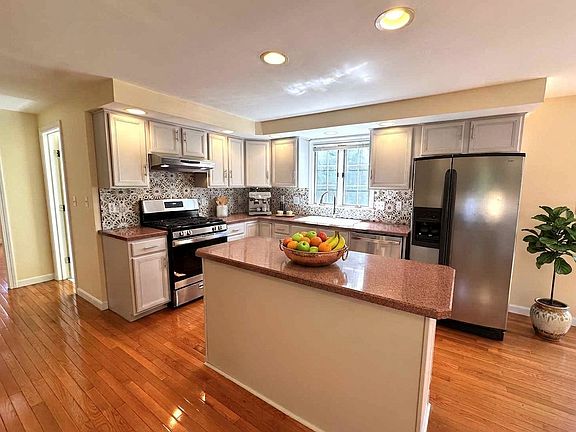 Virtually Staged. The main floor offers a formal living room with decorative fireplace, formal dining room, and cozy family room. The bright eat-in kitchen boasts stainless steel appliances, a BUILT-IN DESK, and sliders to a private deck and yard.