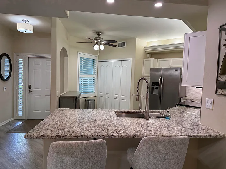 remodeled island height granite counter with extended overhand for pub chairs (furnished)