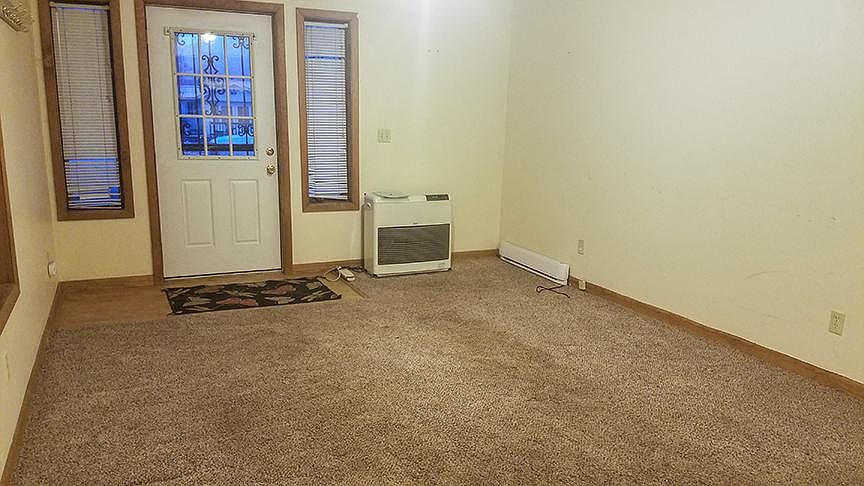 Living room. Efficient heating unit with a backup wall heater. Newly shampooed rugs.