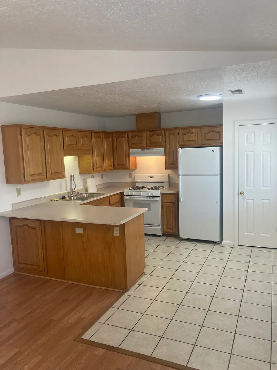 Kitchen and bar seating open to Living Room - 207 Princeton Dr SE #B