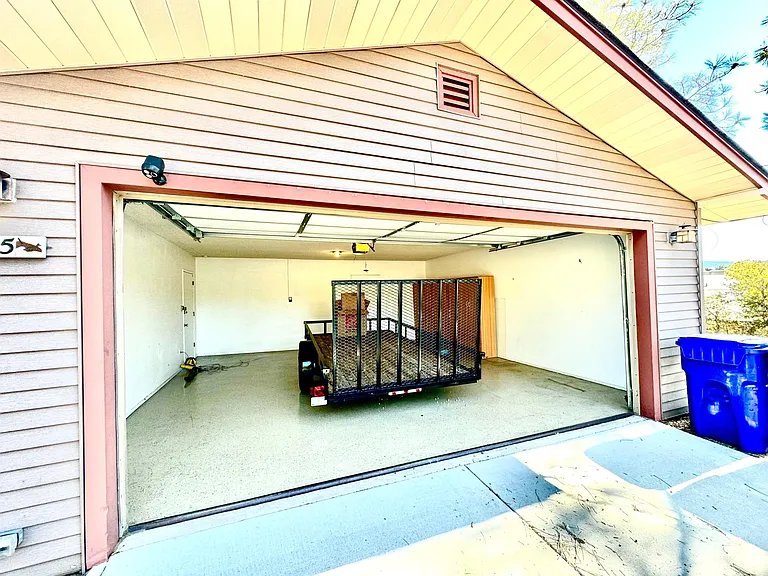Oversized two car garage. The trailer is 14' x 6' with plenty of room in front an back. Trailer not included.
