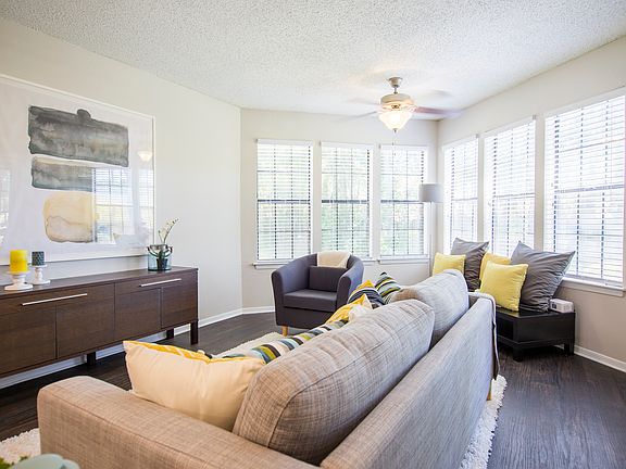 Beautiful furnished model living room with wood inspired plank flooring