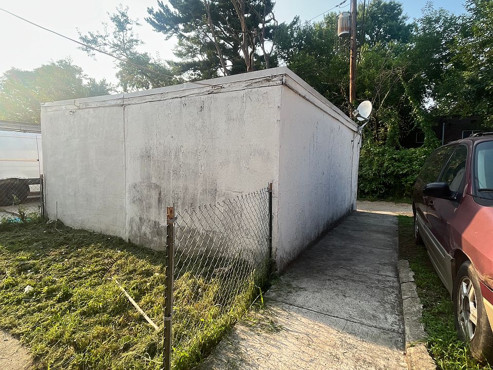 BACK OF GARAGE WHICH CAN BE DRESSED UP WITH GARDENING AND GRILLING SPACE__