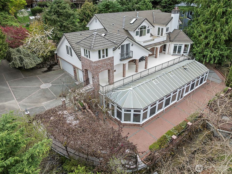 Beautiful & timeless home on Mercer Island's West side. Incredibly private being surrounded by nature. Gorgeous atrium with in ground pool. Elegantly appointed amenities, an abundance of storage throughout & lots of outdoor living space.>