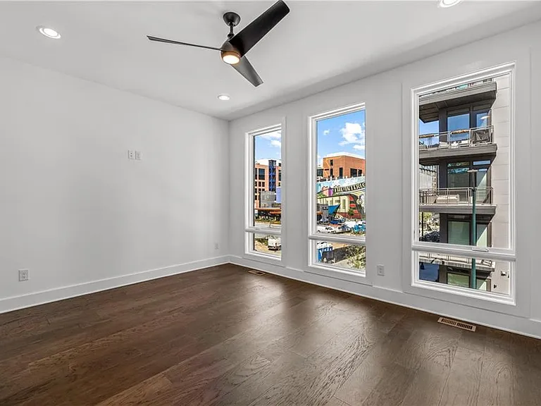Main Bedroom (Note: Actual unit has light wooden floors and upgraded fixtures / appliances)