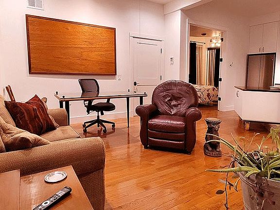 Setup for an office, the desk/table may be arranged for dining. Open spaces allow for wheelchair.