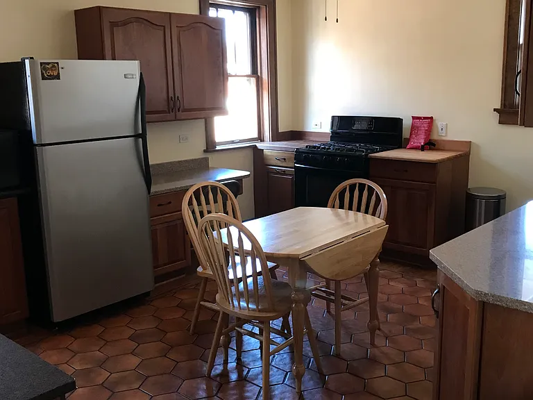 Kitchen, without table. gas stove-oven, ice maker refrigerator, dishwasher, microwave, quartz counters, wood counters flanking stove for hot dishes, office area, under counter lighting, tile-wood floor combination