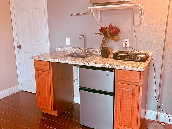 Kitchenette. Includes: 
- 3.2 cu. ft. stainless steel mini refrigerator with freezer
- Microwave
- 2 Burner Cooktop_ideal for simple meal prep.
