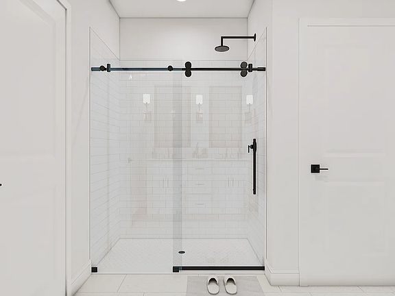 Primary bath shower with glass door and tile surround