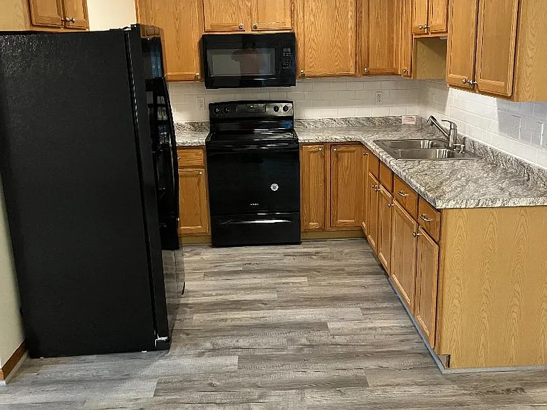 kitchen renovated with new fixtures, countertop, flooring and fresh paint