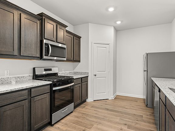 The kitchen has gorgeous wood cabinetry.