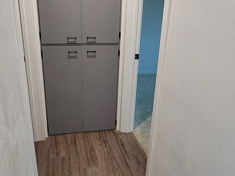 hall way closet with shelfs to left main bathroom to the right bedroom with half bath