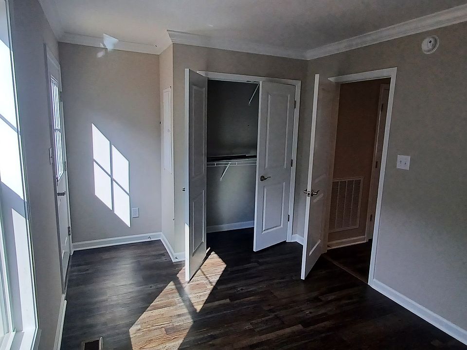 Bedroom with closet and door leading to backyard. Dimensions 12'8" x 9'2"