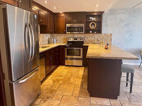 Kitchen - Modern kitchen with granite counters and stainless-steel appliances.