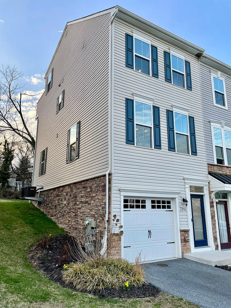 End-unit townhome with blossoming landscaping. - 7042 Cedar Ave
