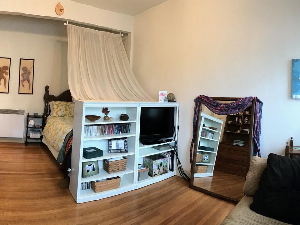 This resident placed her bed at the end of living area