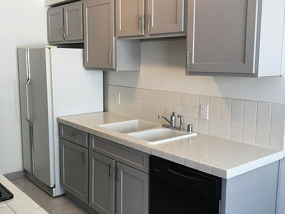 Appliances include microwave, cooktop, oven and fridge