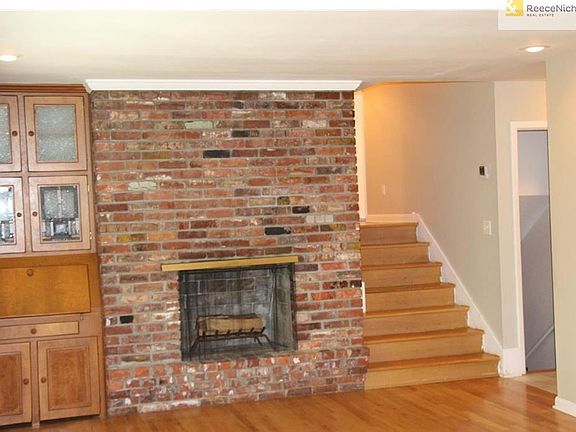 Stairs from living room head up to bedrooms.