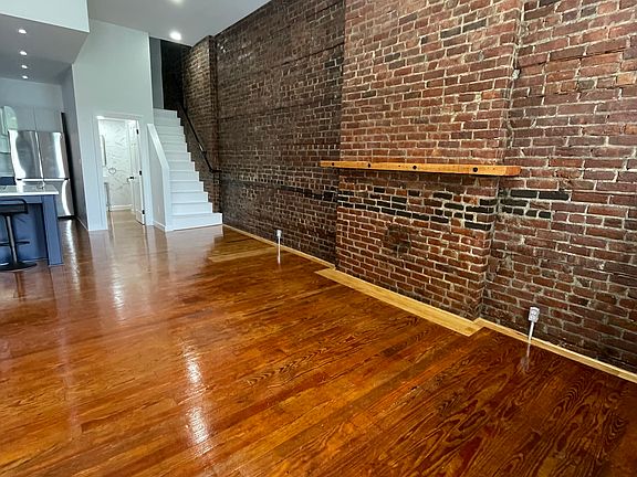 Open living room with view of stairs to 2nd floor