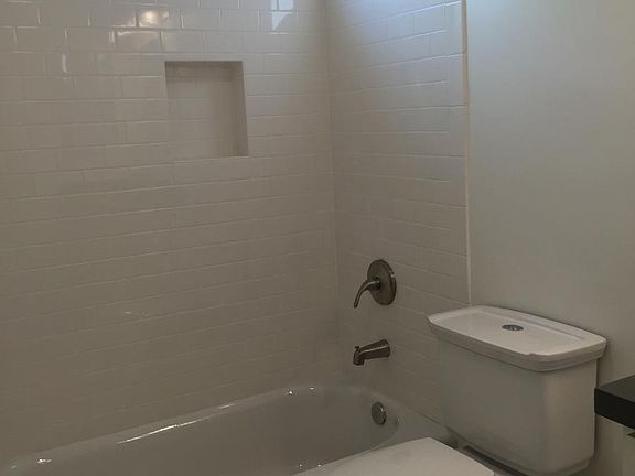 Gutted and remodeled bathroom with subway tile shower and cu