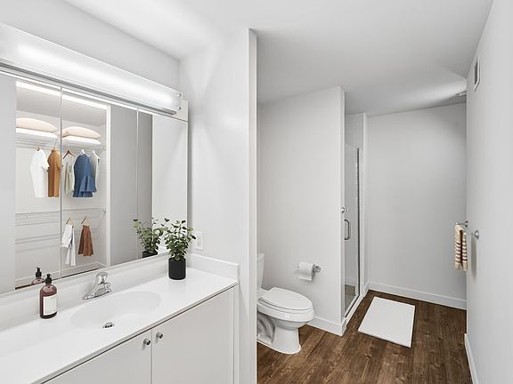 Bath with white cabinetry, white quartz countertops, and hard surface flooring