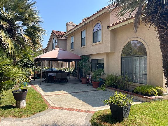 Open backyard with gazebo, natural gas barbecue hook ups.