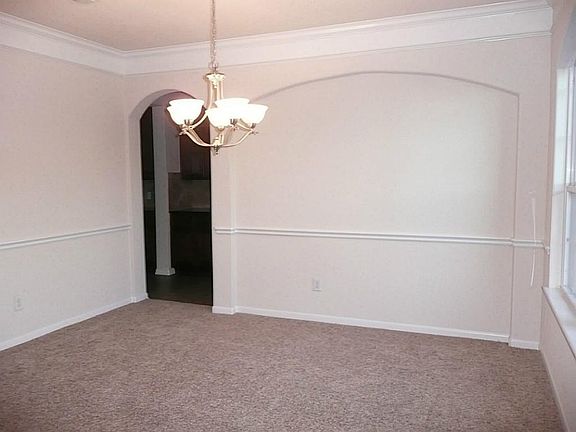 DINING ROOM WITH CHAIR RAIL- NEW CARPET AND INTERIOR PAINT.