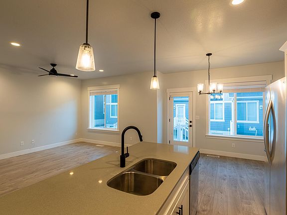 Living room and dining area. View from kitchen.
