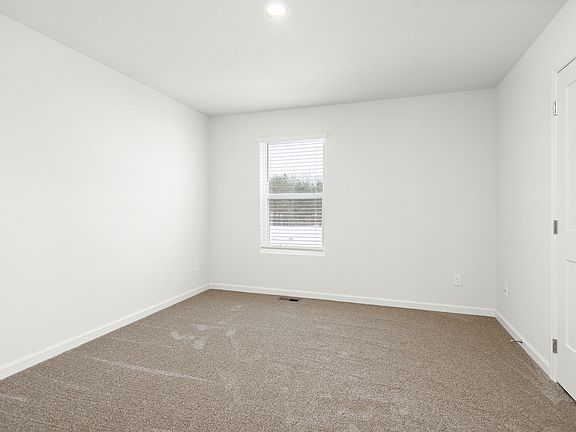 The master bedroom is spacious and has plenty of natural light