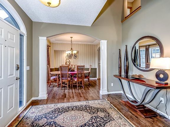 Vaulted entry with solid wood floors