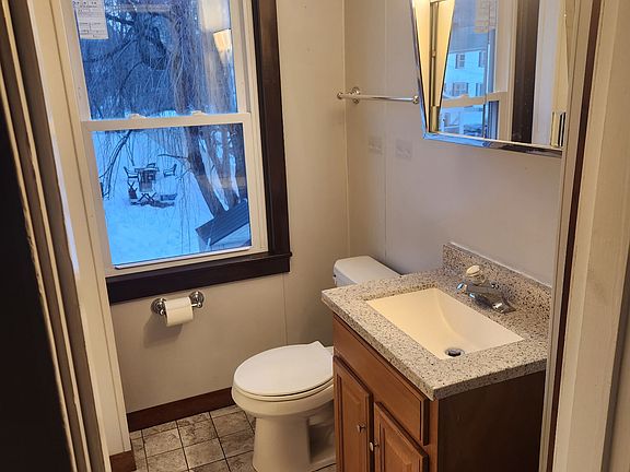 Tile floor bathroom showing toilet and vanity.