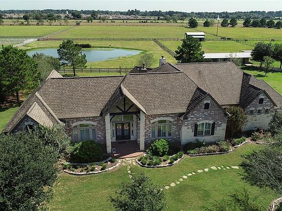 Beautiful one story custom home with brick, stone, and wood beams. Home sets on high elevation as the pond was dug first during the construction process in 2007. The excavated dirt was used to raise the elevation before the foundation was poured. Thi