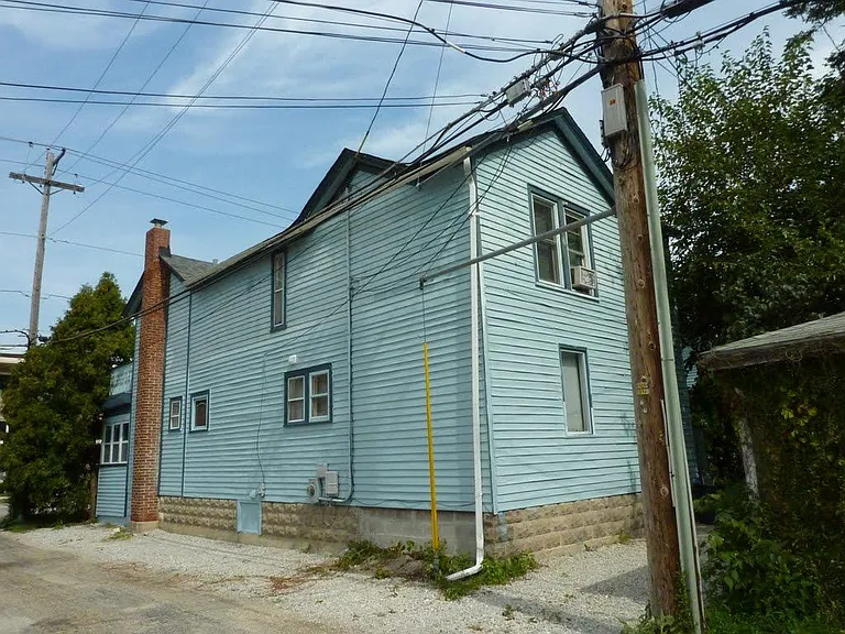 Back of home - one car parking on side of house