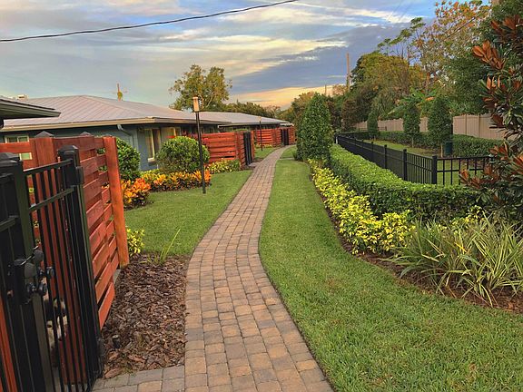 Backside of villas facing the dog park and a perimeter fence. (2 units face this view & 2 units have a street view)