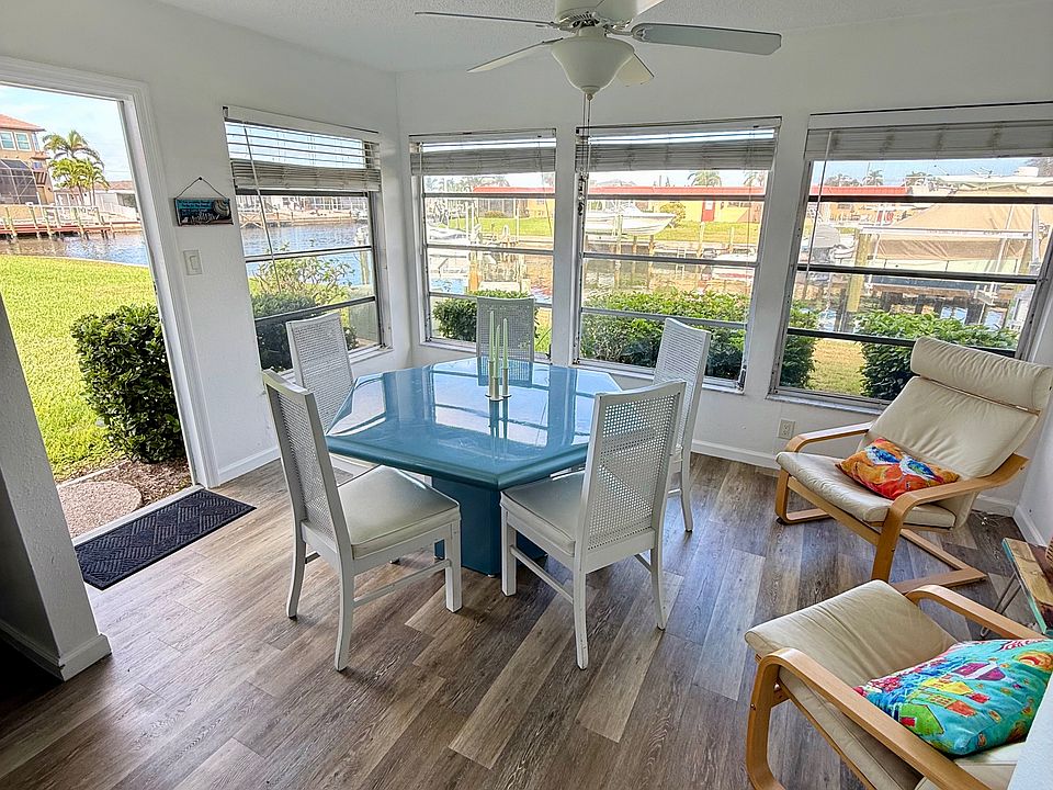 Beautifully lit sunroom overlooking the canal, offering a peaceful spot to relax any time.