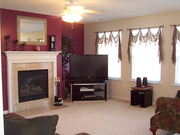 Light & bright family room with Marble surround, gas log fireplace