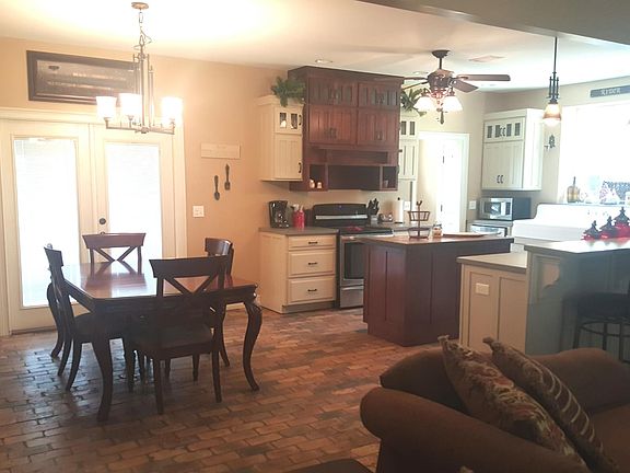Inside the front door shot of the kitchen and dining area open to the great room or living area as well.