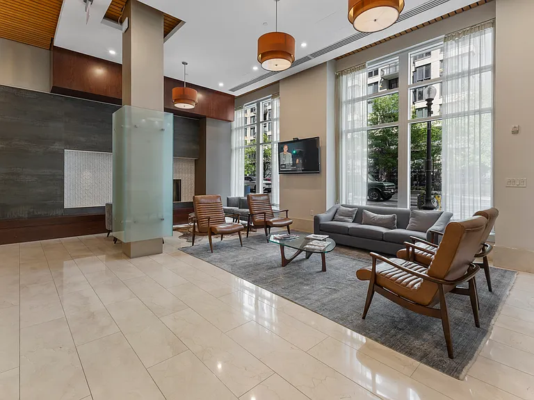 Experience a grand welcome in the building's designer lobby, offering a sophisticated lounge area for guests or quiet reading.