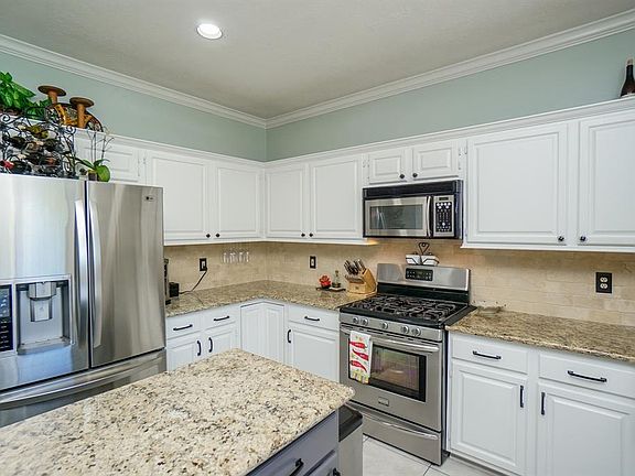 I know you are curious about the kitchen, so lets go there! You won't be disappointed with the white cabinets and granite counter tops.