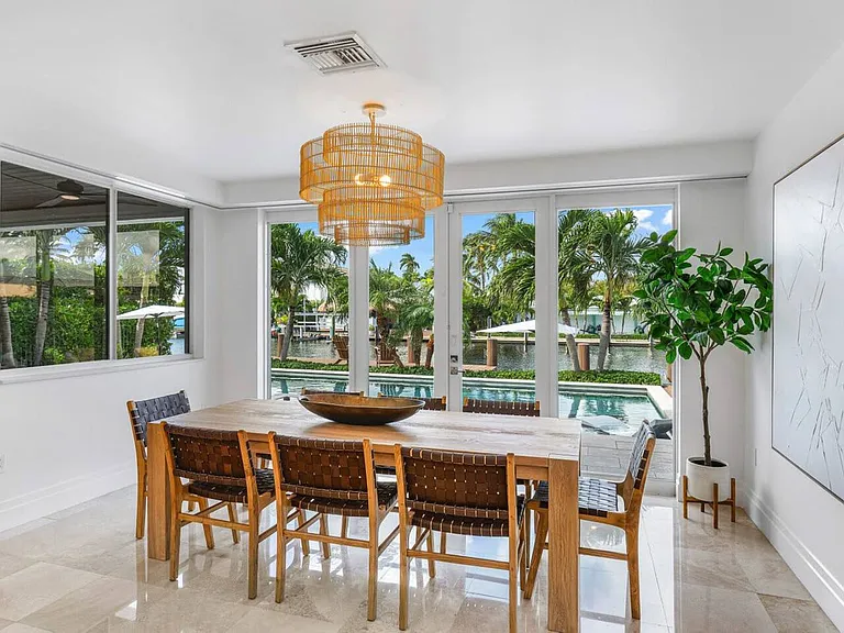 Open, sunlit dining space surrounded by greenery, ideal for enjoying meals with a beautiful backdrop.