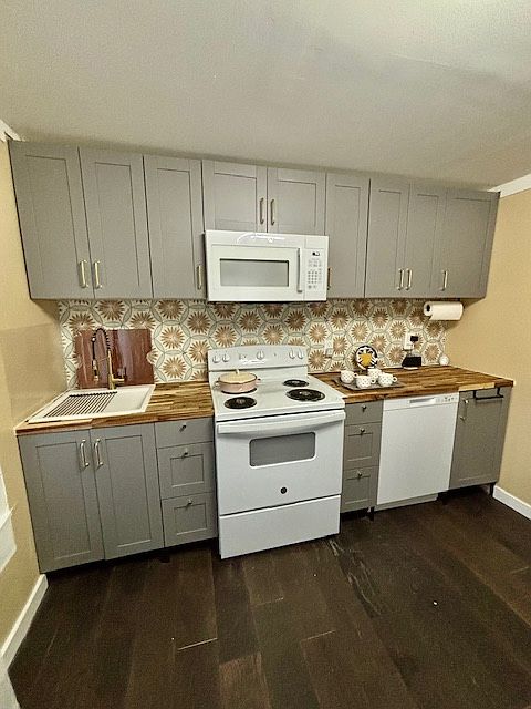 New cabinets, an over-the-range microwave, a full-size dishwasher and refrigerator, two-function faucet sprayhead, a porcelain backsplash, and butcher block countertops await.