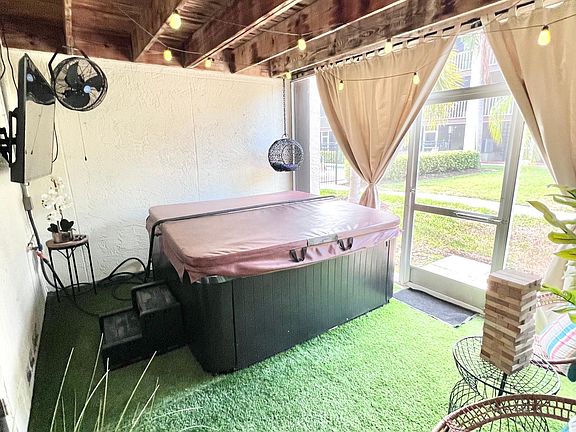 First floor patio off garage with hot tub