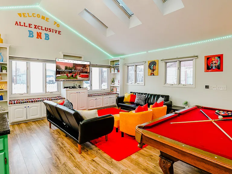 A sophisticated open space featuring a sleek pool table set against a rich red carpet, combining luxury with leisure for the ultimate gaming experience.
