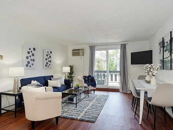 Sunny bright living area with wall a/c and new slider to bright private balcony