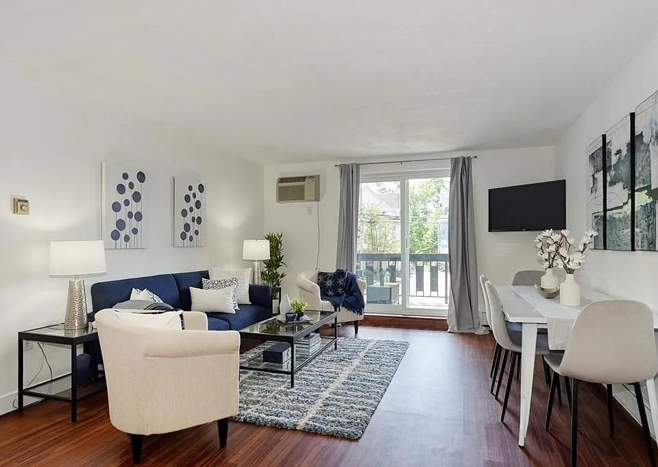 Sunny bright living area with wall a/c and new slider to bright private balcony