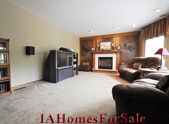 Living Room featuring the hand-painted torn paper wall with gas fireplace.