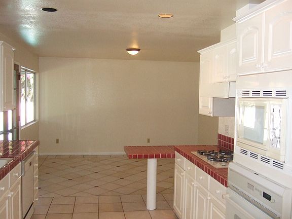 Nice Kitchen that opens to outside, double doors, covered patio, and pool!