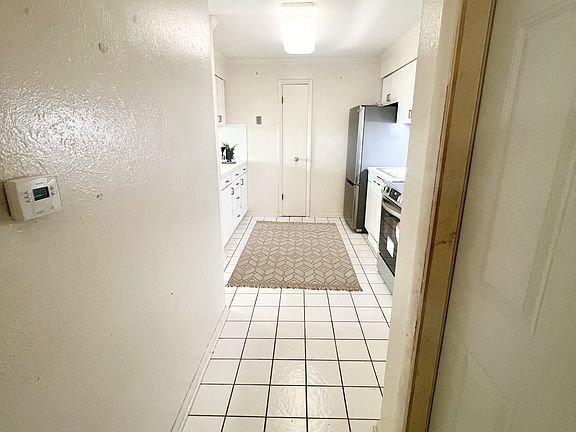 Second entrance hallway leading to kitchen