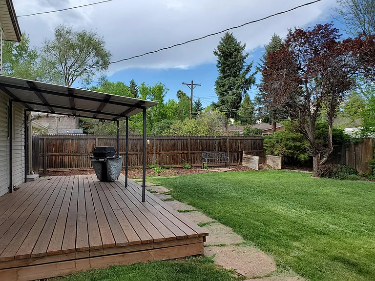 Spacious back yard including covered deck.
